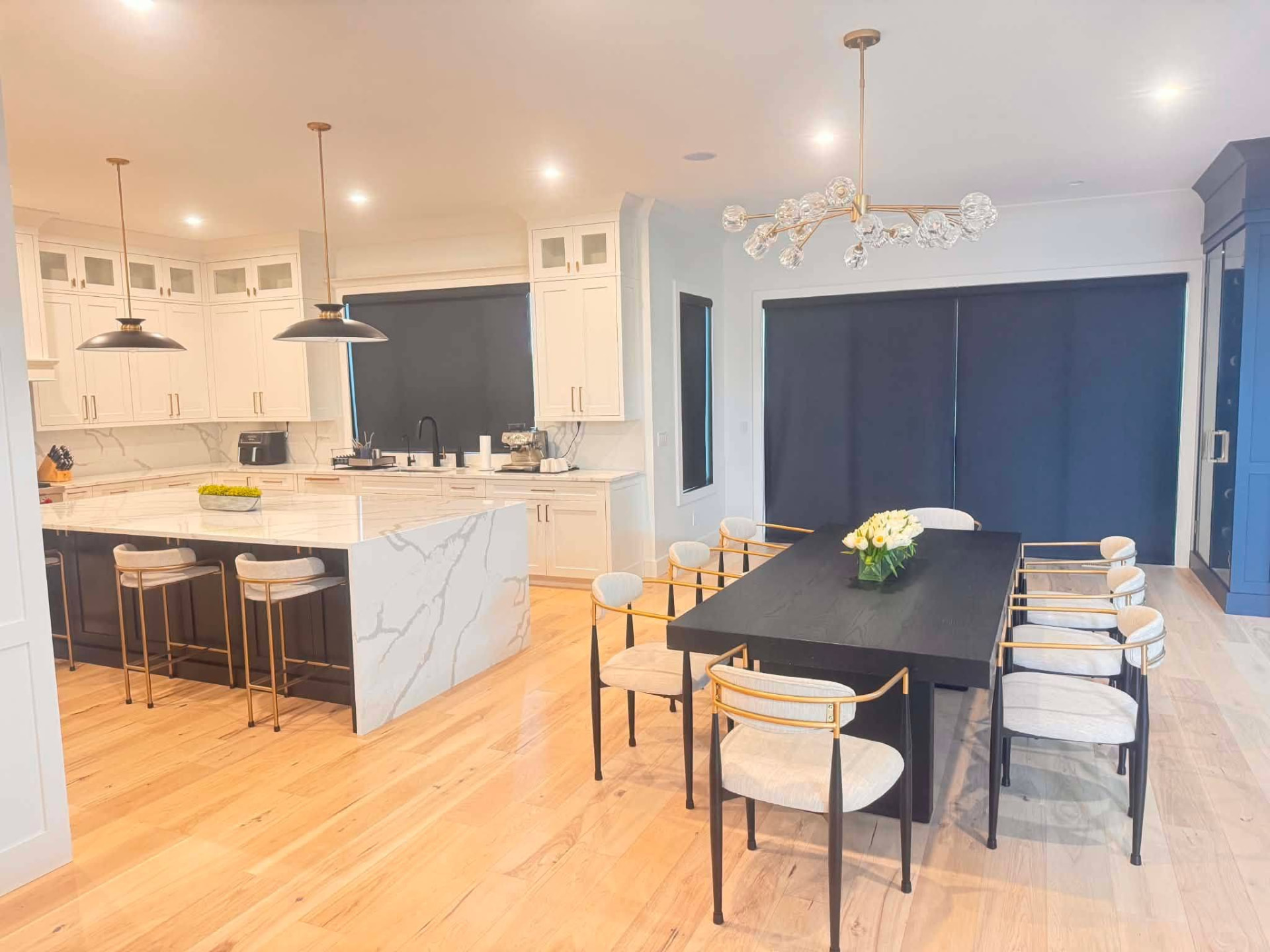 Spotless open kitchen and dining room with marble island