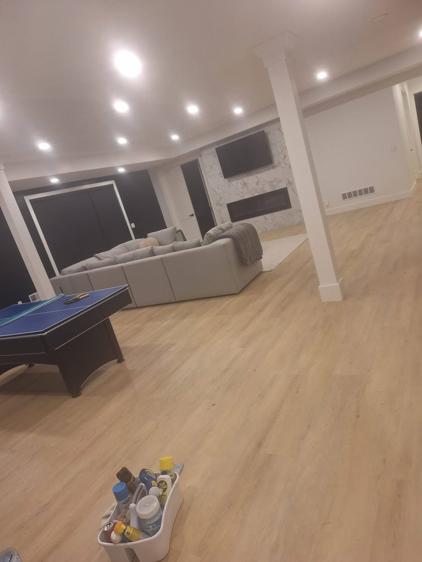 Clean finished basement with game table
