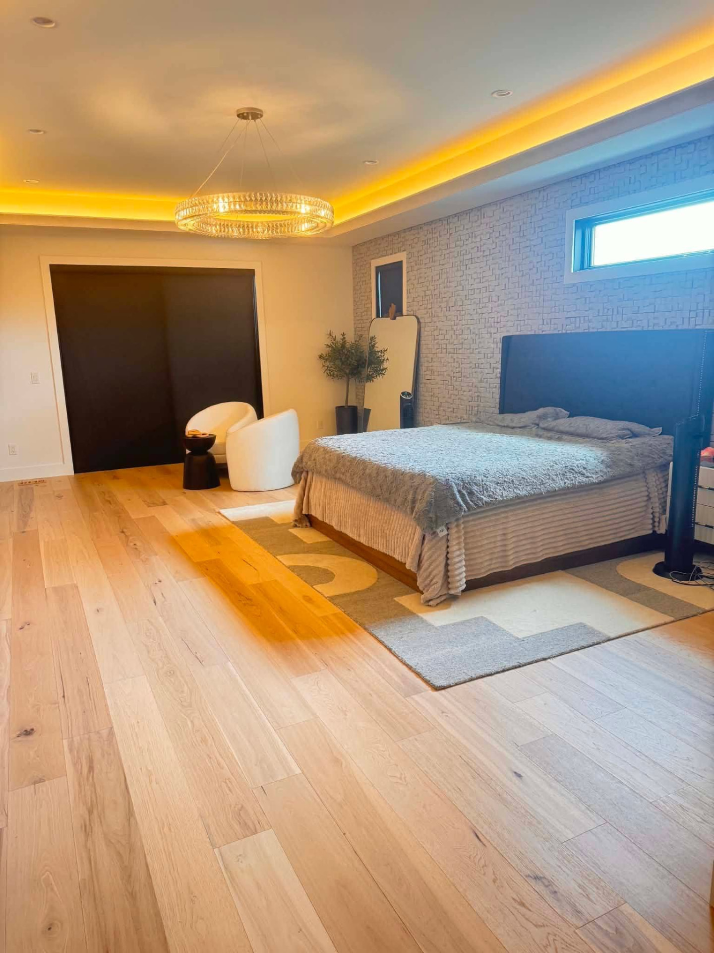 Spotless bedroom with light wood floors