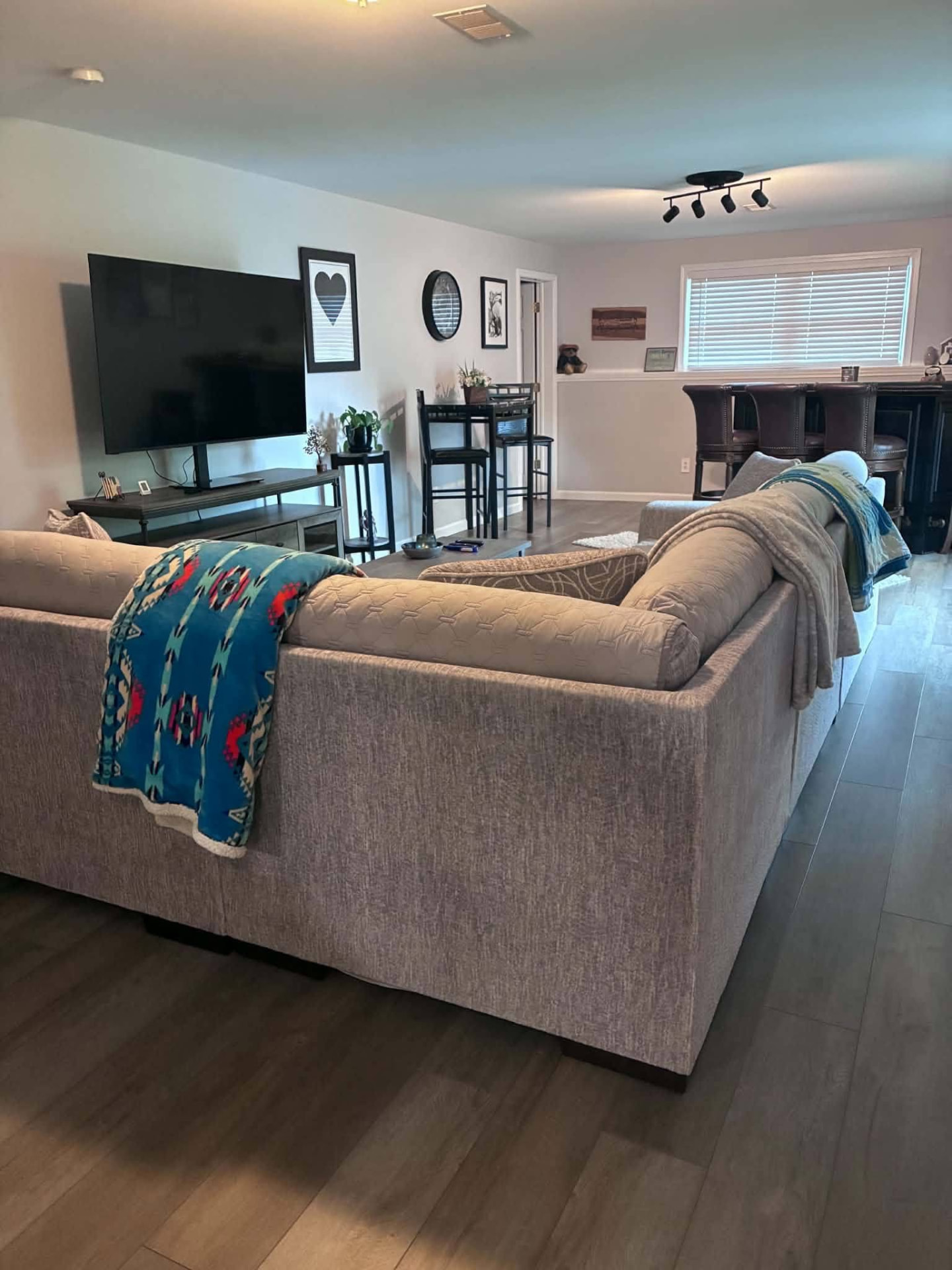 Tidy living room with sectional sofa and clean wood floors
